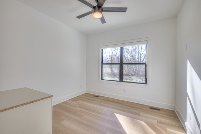 unfurnished room featuring ceiling fan and light hardwood / wood-style flooring