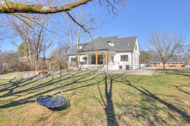 back of house with a lawn and a patio