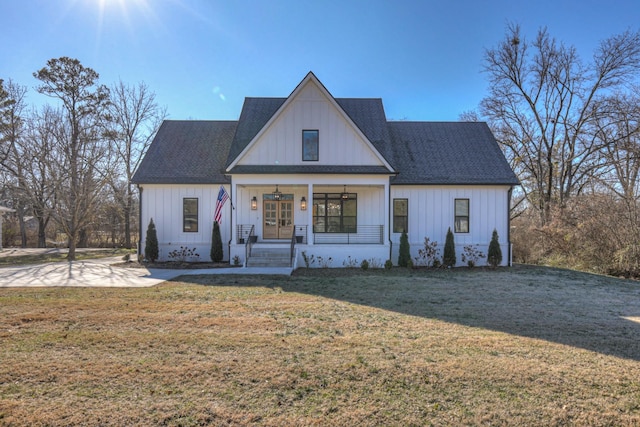 modern farmhouse style home with a porch and a front yard