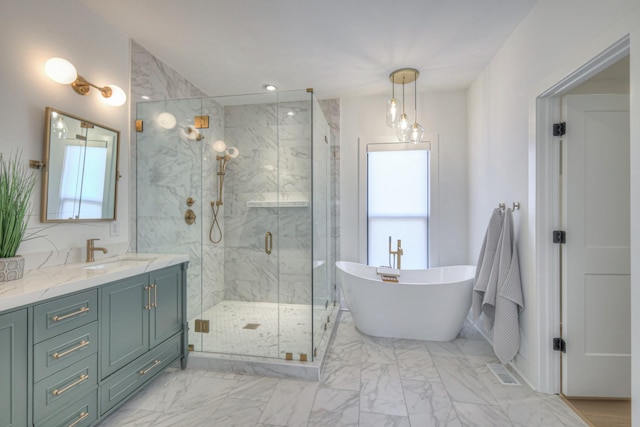 bathroom with vanity and independent shower and bath