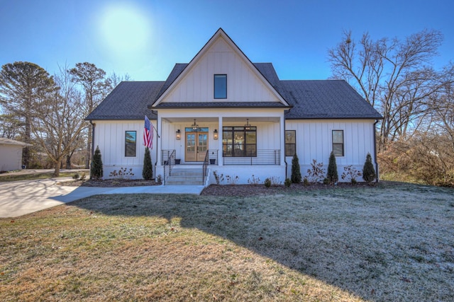 modern farmhouse style home with covered porch and a front lawn