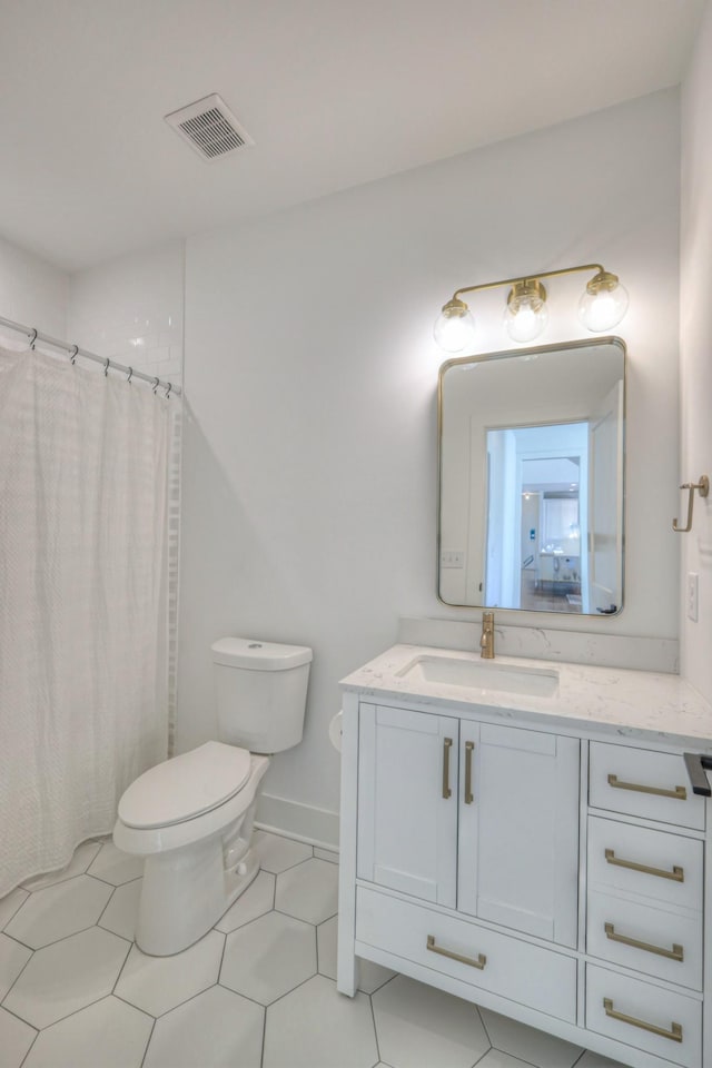 bathroom with walk in shower, vanity, and toilet