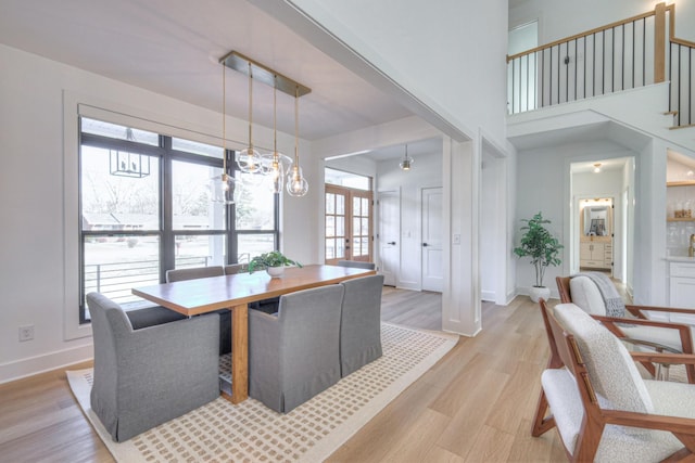 dining room with light hardwood / wood-style floors and french doors