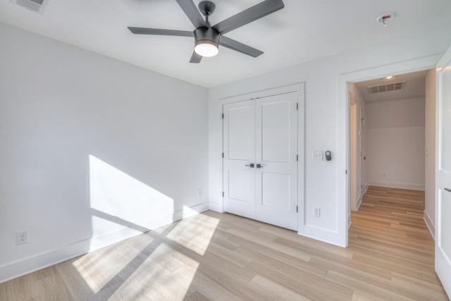 unfurnished bedroom with a closet, ceiling fan, and light hardwood / wood-style flooring