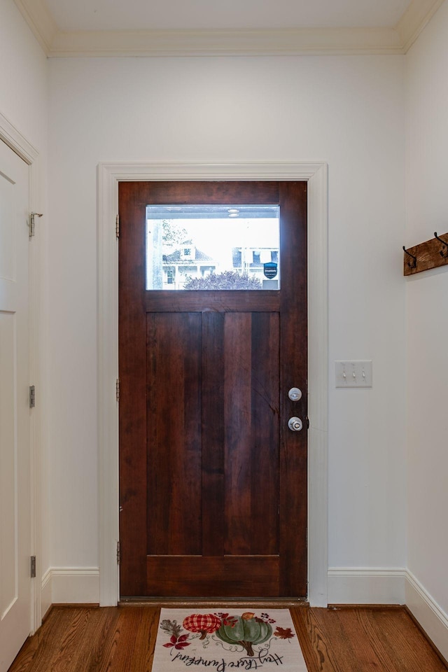 foyer with crown molding and hardwood / wood-style floors