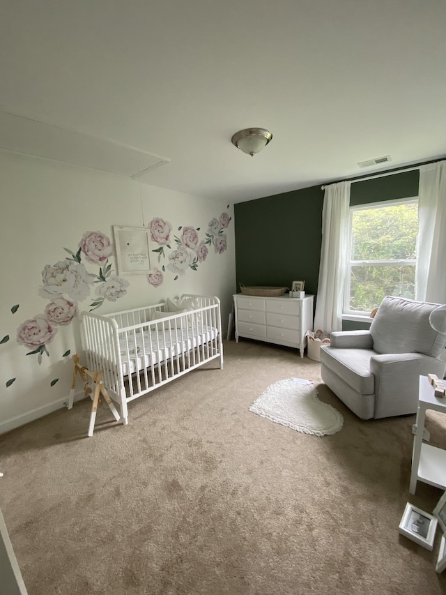 bedroom featuring carpet flooring and a crib