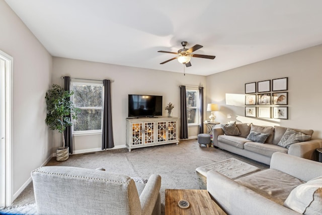 living room featuring ceiling fan and carpet