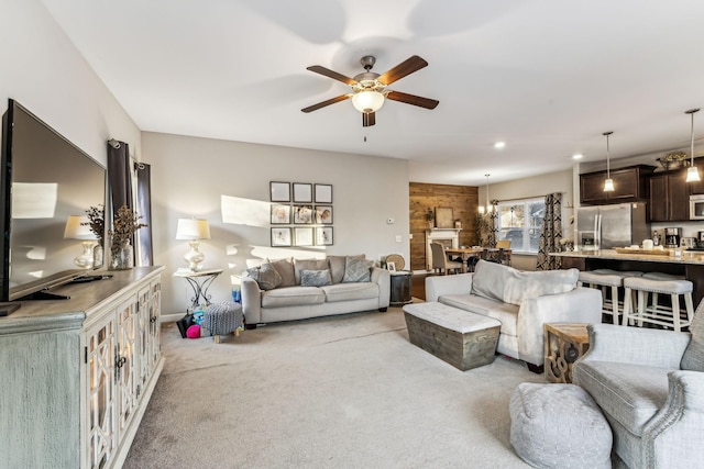 carpeted living room with ceiling fan