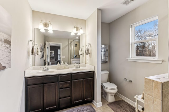 bathroom with tile patterned flooring, vanity, and toilet