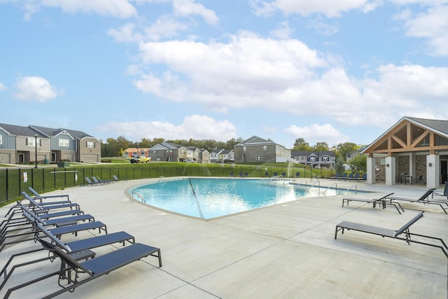 view of swimming pool with a patio area and a lawn