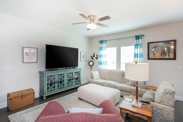 living room featuring dark wood-type flooring and ceiling fan