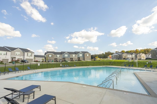 view of swimming pool with a patio and a yard