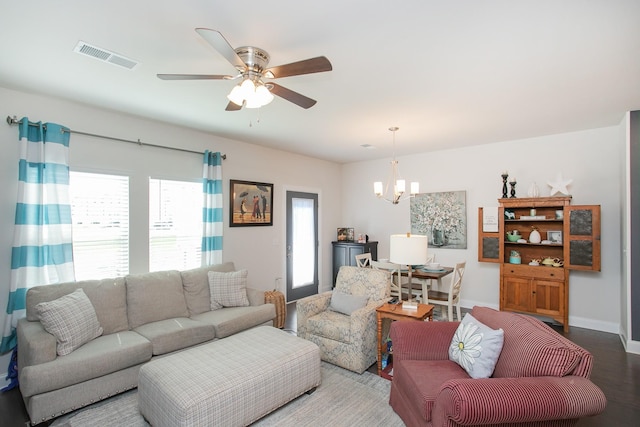 living room with hardwood / wood-style flooring and ceiling fan with notable chandelier