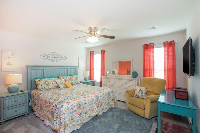 carpeted bedroom with multiple windows and ceiling fan