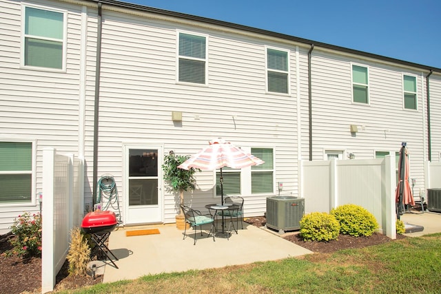 back of property with cooling unit and a patio area