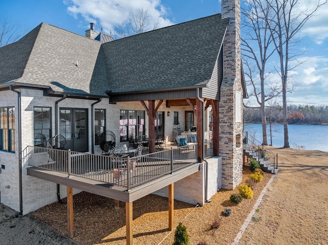 back of house featuring a water view