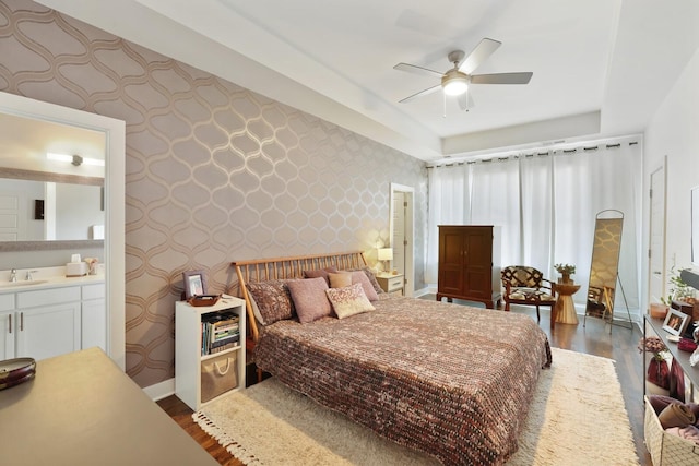 bedroom with ceiling fan, dark hardwood / wood-style floors, and sink