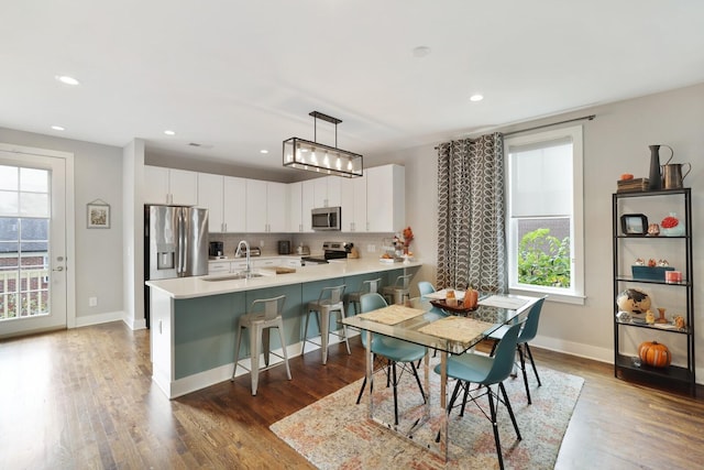 dining room featuring dark hardwood / wood-style flooring and sink