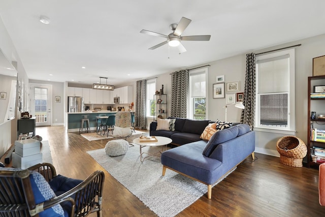 living room featuring dark hardwood / wood-style flooring and ceiling fan