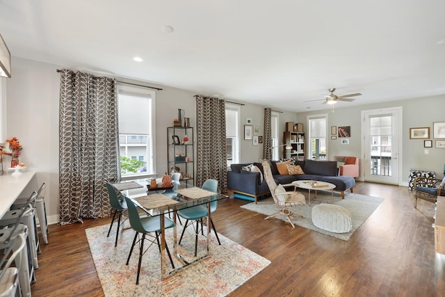 dining space with dark wood-type flooring and ceiling fan