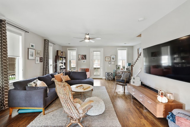 living room with ceiling fan, plenty of natural light, and dark hardwood / wood-style floors