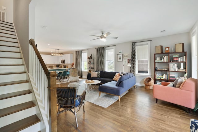 living room featuring hardwood / wood-style flooring and ceiling fan