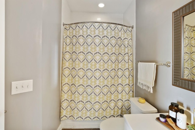 bathroom featuring vanity, curtained shower, and toilet