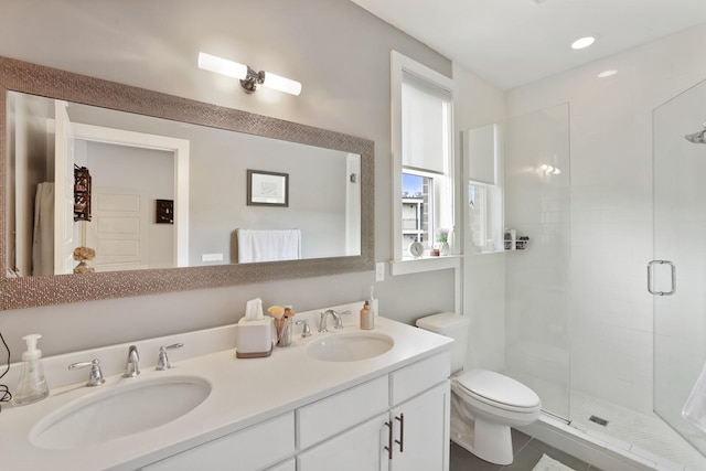 bathroom featuring vanity, an enclosed shower, and toilet