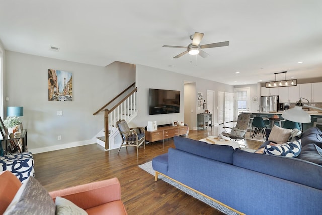 living room featuring dark hardwood / wood-style floors and ceiling fan