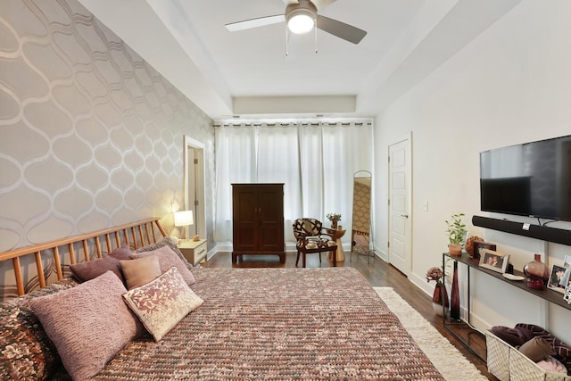 bedroom with dark hardwood / wood-style floors and ceiling fan