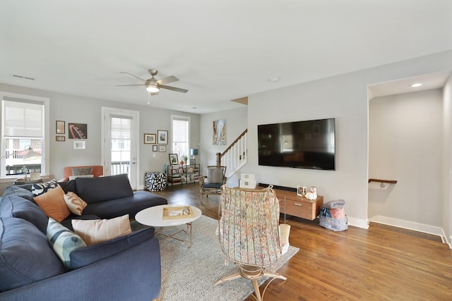 living room featuring hardwood / wood-style flooring and ceiling fan