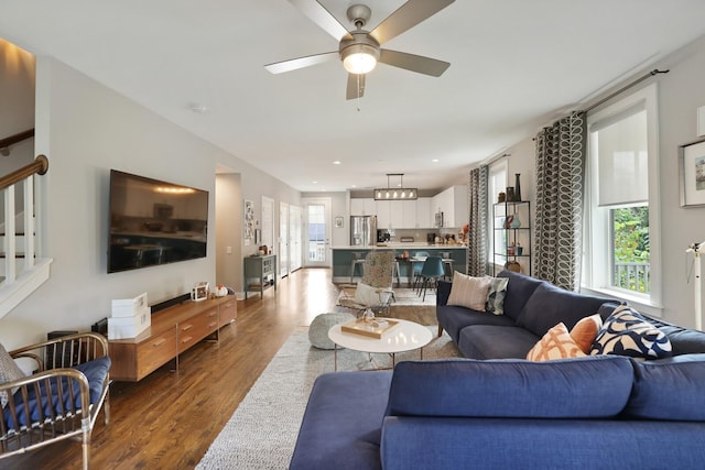 living room with wood-type flooring and ceiling fan