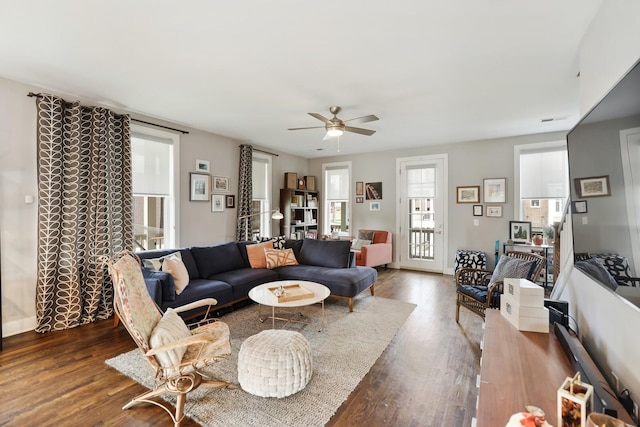 living room with dark hardwood / wood-style floors and ceiling fan