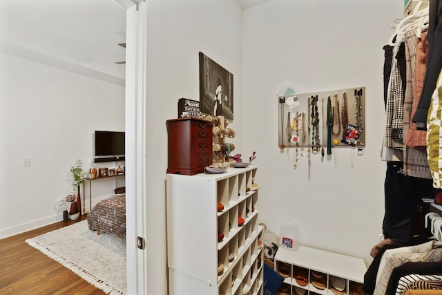 corridor with hardwood / wood-style floors