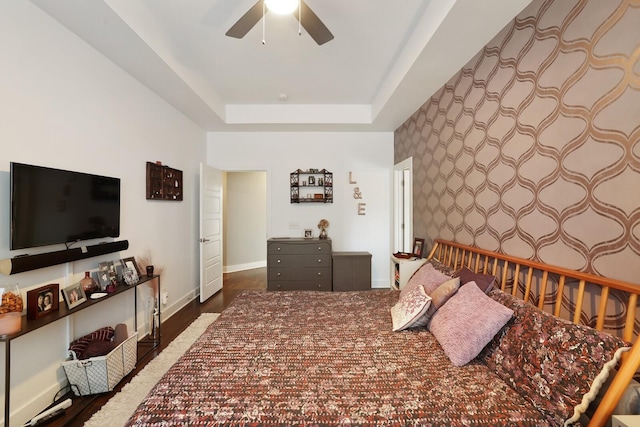 bedroom featuring a tray ceiling and ceiling fan