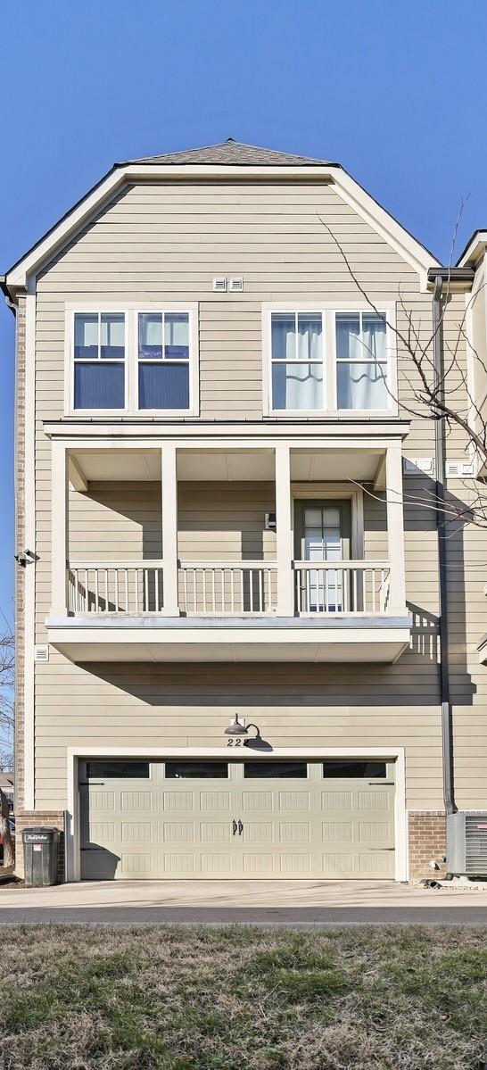 view of front of house featuring a garage and a balcony