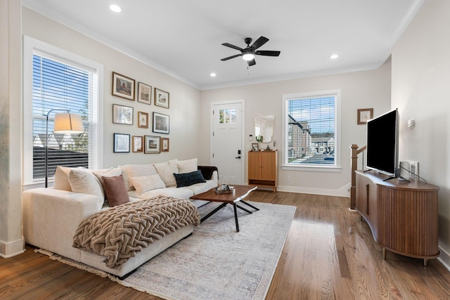 living area featuring ceiling fan, recessed lighting, wood finished floors, baseboards, and crown molding