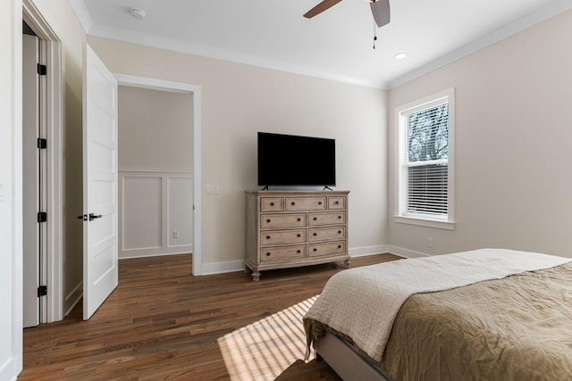 bedroom with baseboards, a ceiling fan, dark wood-style flooring, and crown molding