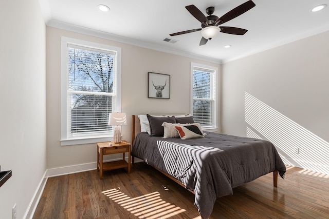 bedroom featuring baseboards, recessed lighting, wood finished floors, and crown molding