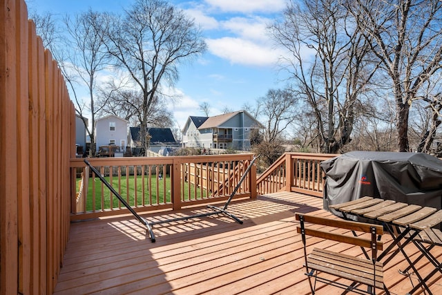 wooden deck with a residential view and a yard