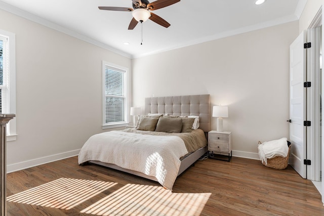 bedroom featuring a ceiling fan, crown molding, baseboards, and wood finished floors