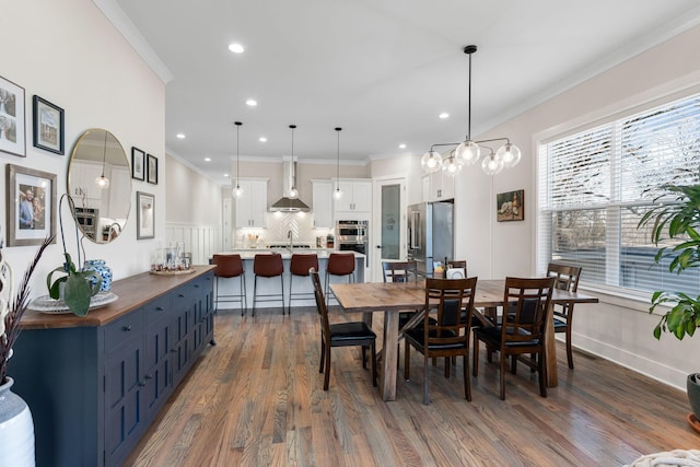 dining space with ornamental molding, recessed lighting, and dark wood finished floors