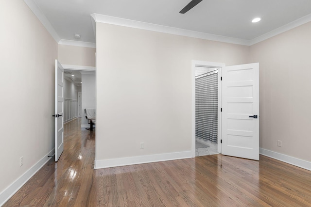 spare room with baseboards, ceiling fan, ornamental molding, wood finished floors, and recessed lighting