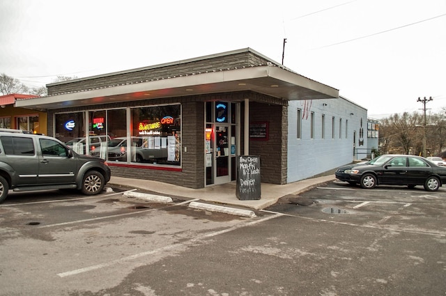 view of building exterior featuring uncovered parking