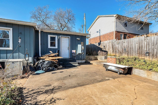 rear view of property with cooling unit and a patio area