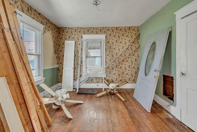 miscellaneous room with wood-type flooring and a textured ceiling