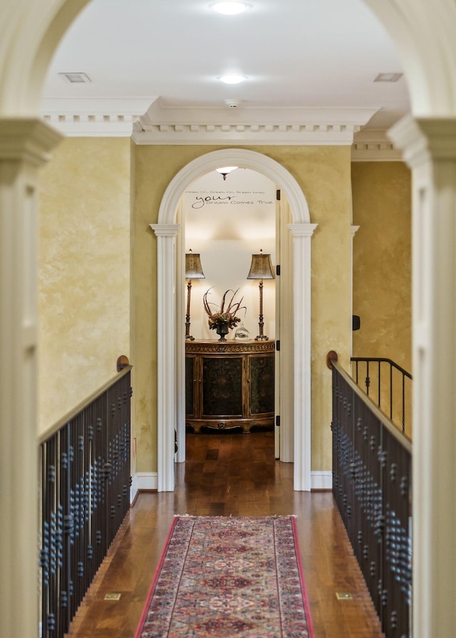 hallway with ornamental molding and dark hardwood / wood-style flooring