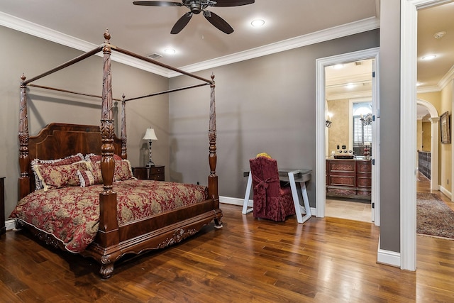 bedroom featuring crown molding, ceiling fan, ensuite bathroom, and hardwood / wood-style floors