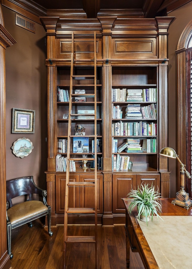 sitting room featuring dark wood-type flooring and beamed ceiling