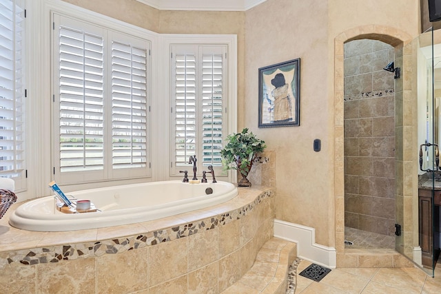 bathroom featuring tile patterned floors and separate shower and tub